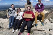 Jon Velotta and his students researchers sit at the top of Mt Blue Sky, formerly known as Mt. Evans.
